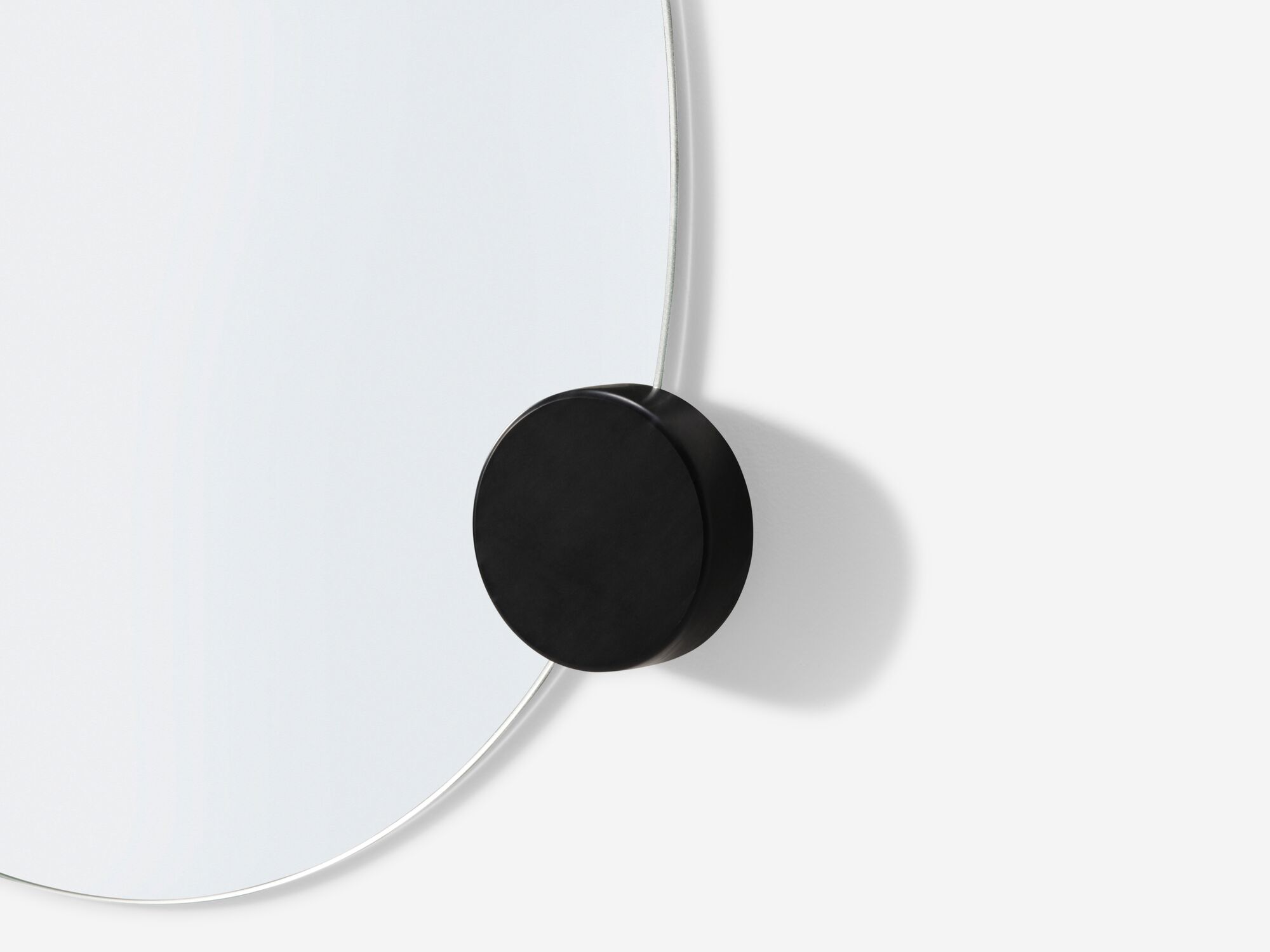 Detail view of large wall mirror with black knobs